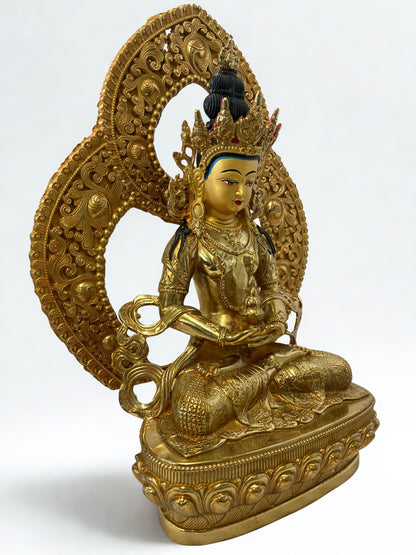 Gold-colored statue of a seated Amitayus Buddha Statue with intricate detailing on a white background