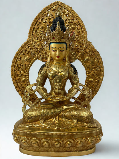 Gold-colored Amitayus Buddha statue with intricate designs on a white background