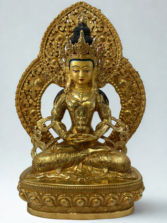 Gold-colored Amitayus Buddha statue with intricate designs on a white background