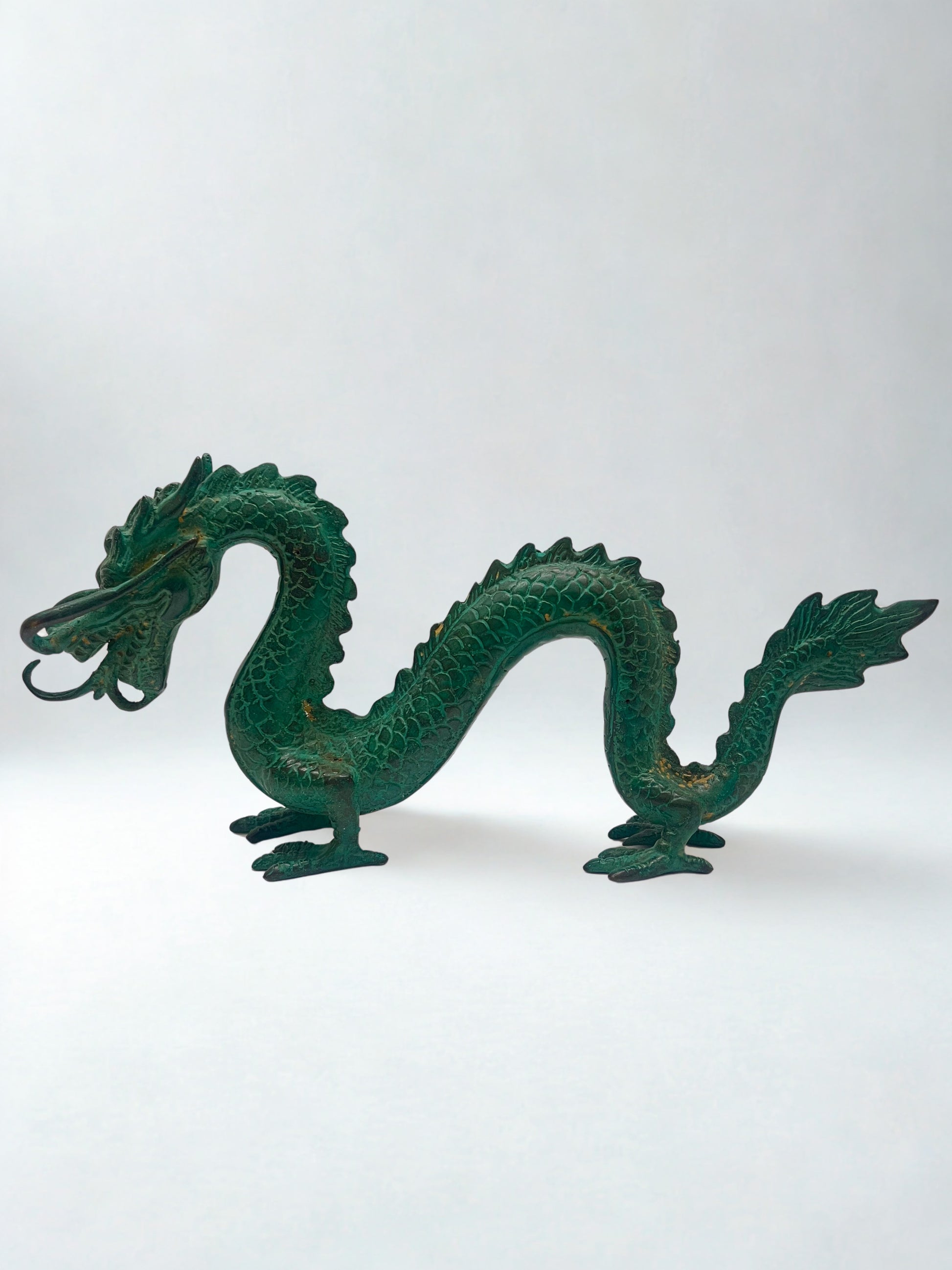 Green dragon sculpture on a white background