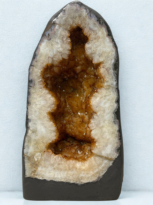 Citrine Geode with brown interior on a white background