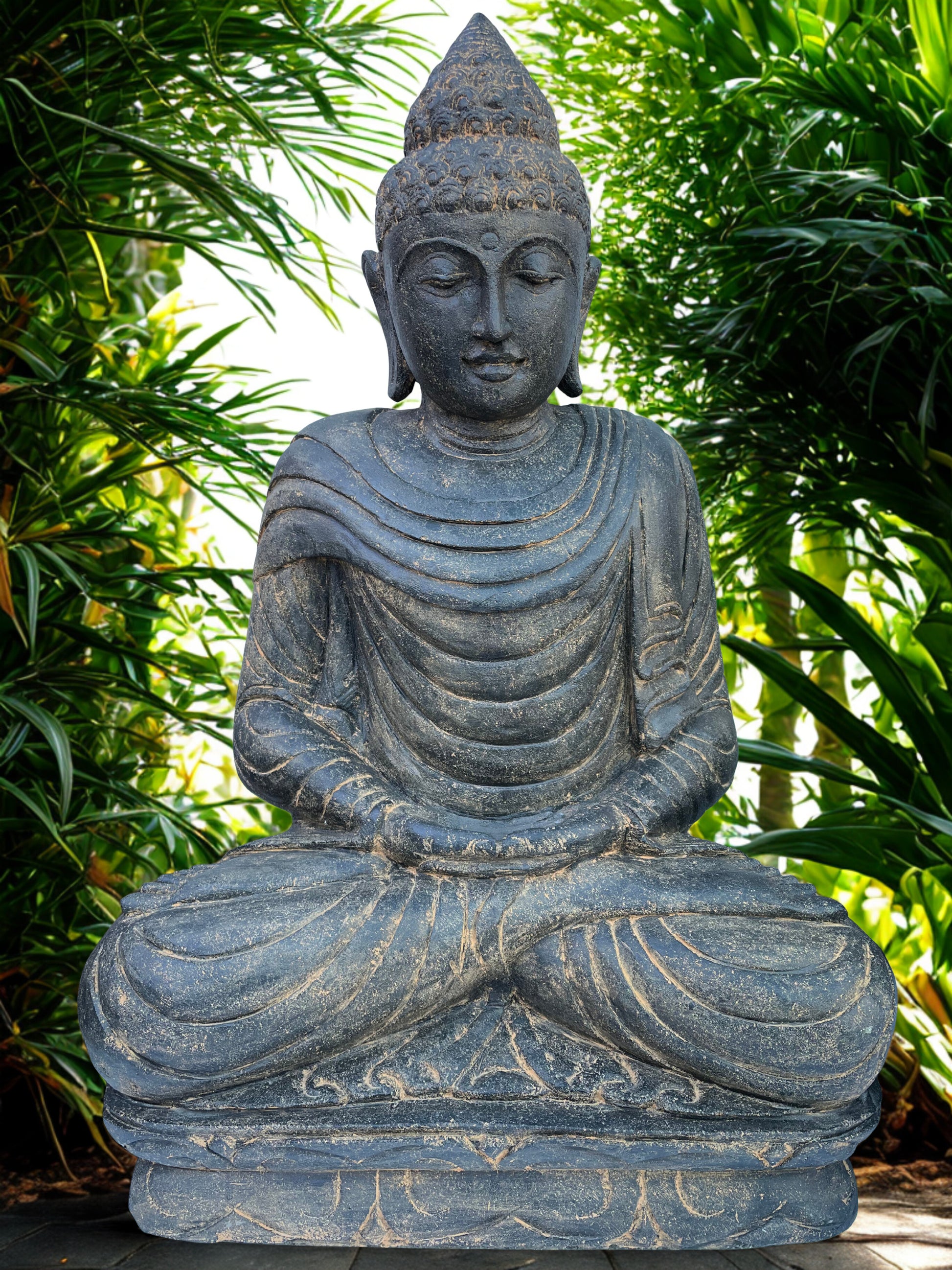 Stone Buddha statue in a garden setting with greenery