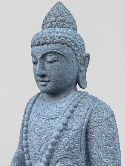Stone statue of a seated Buddha on a light gray background