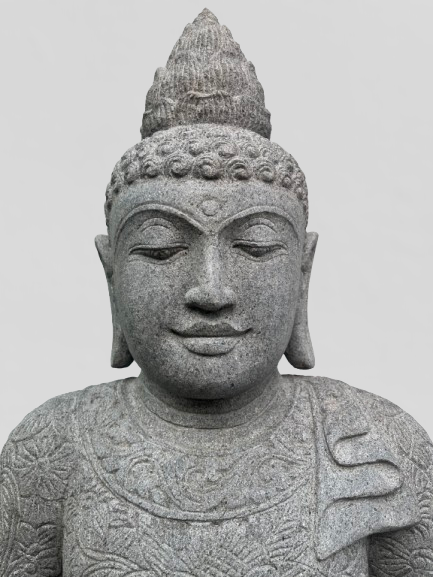 Stone statue of a Buddha with intricate details on a plain background