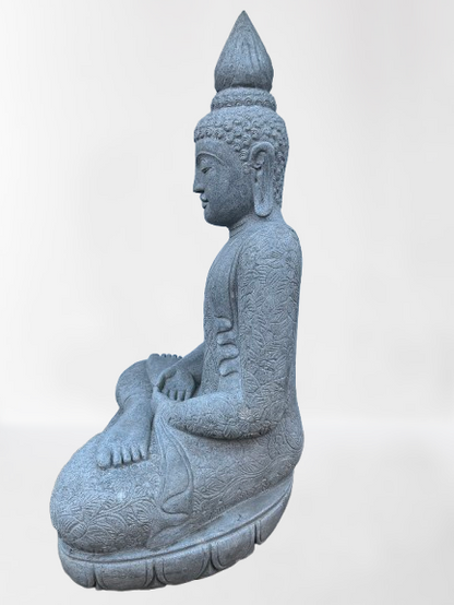 Stone sculpture of a seated Buddha figure on a white background