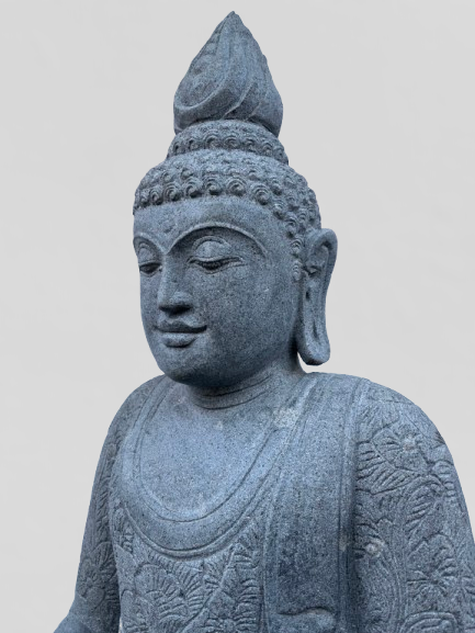 Stone statue of a Buddha figure on a plain background