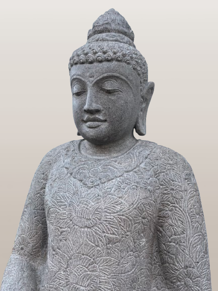 Stone statue of a seated Buddha with intricate patterns on a plain background