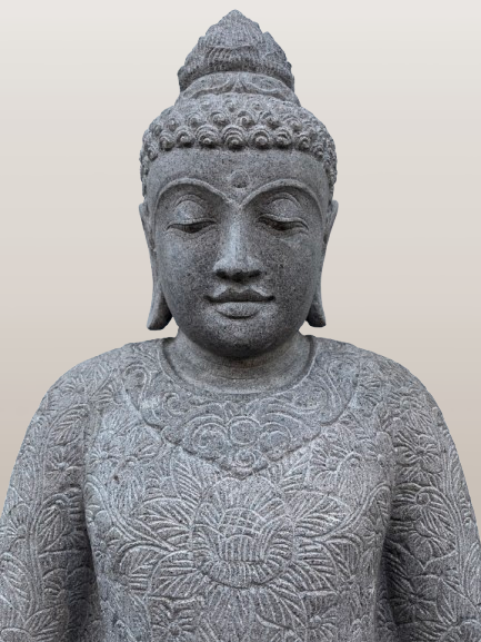 Stone statue of a Buddha figure with intricate carvings on a plain background
