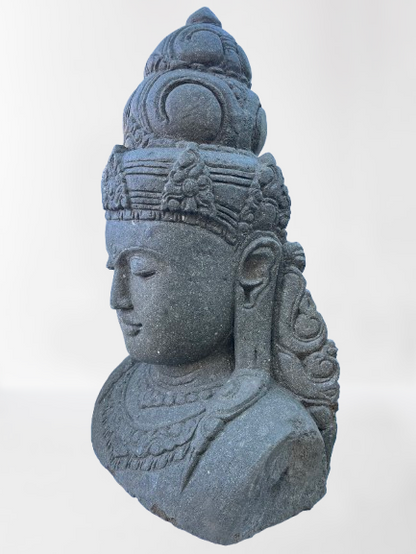 Stone sculpture of a face with intricate details on a white background