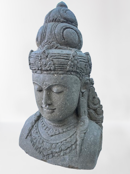 Stone sculpture of a face with intricate details on a white background