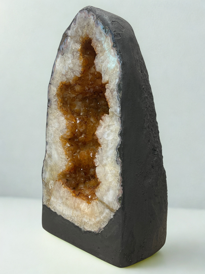 Citrine Geode with brown interior and white exterior on a light gray background