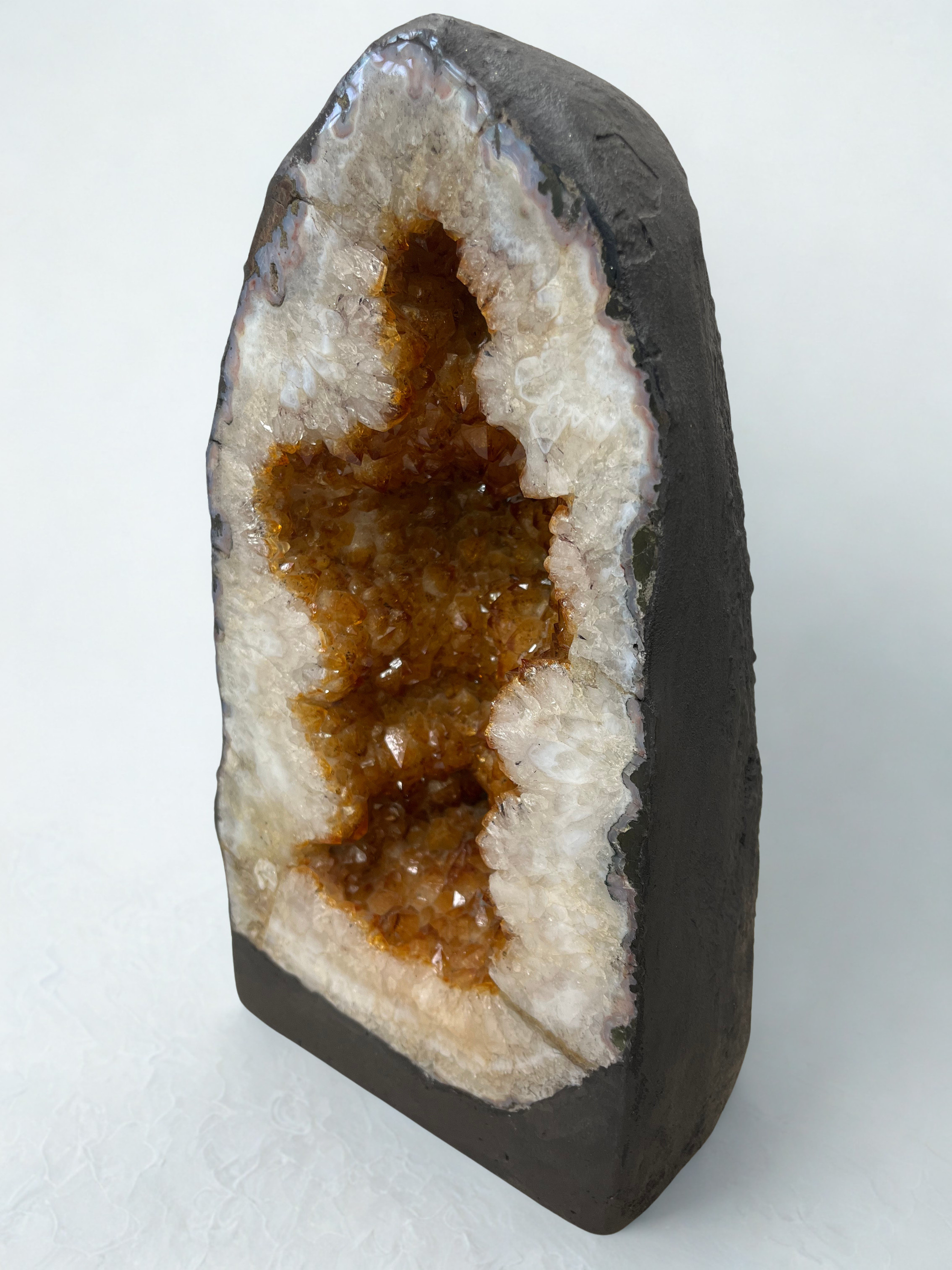 Citrine Geode with brown interior on a white background