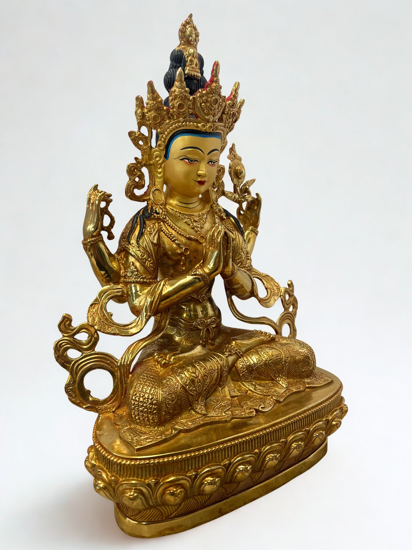 Gold-colored Chenrezig statue on a white background, Tibetan Chenrezig statue, brass Avalokiteshvara sculpture, Buddhist compassion deity, Himalayan art statue, meditation altar décor, spiritual home decoration