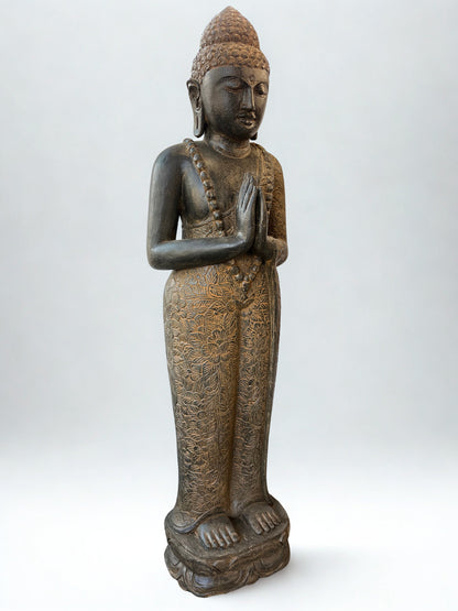 Bronze statue of a standing Buddha on a white background