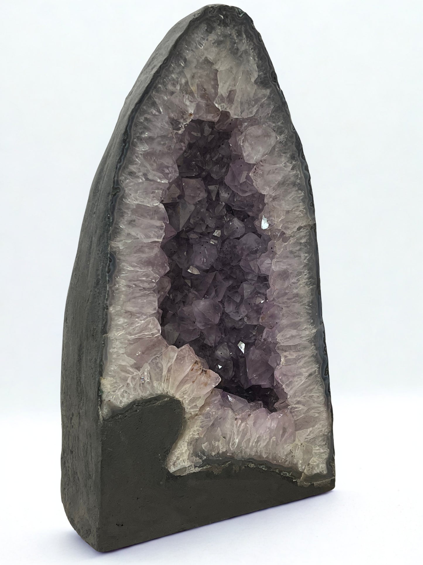 Geode with purple crystals on a white background