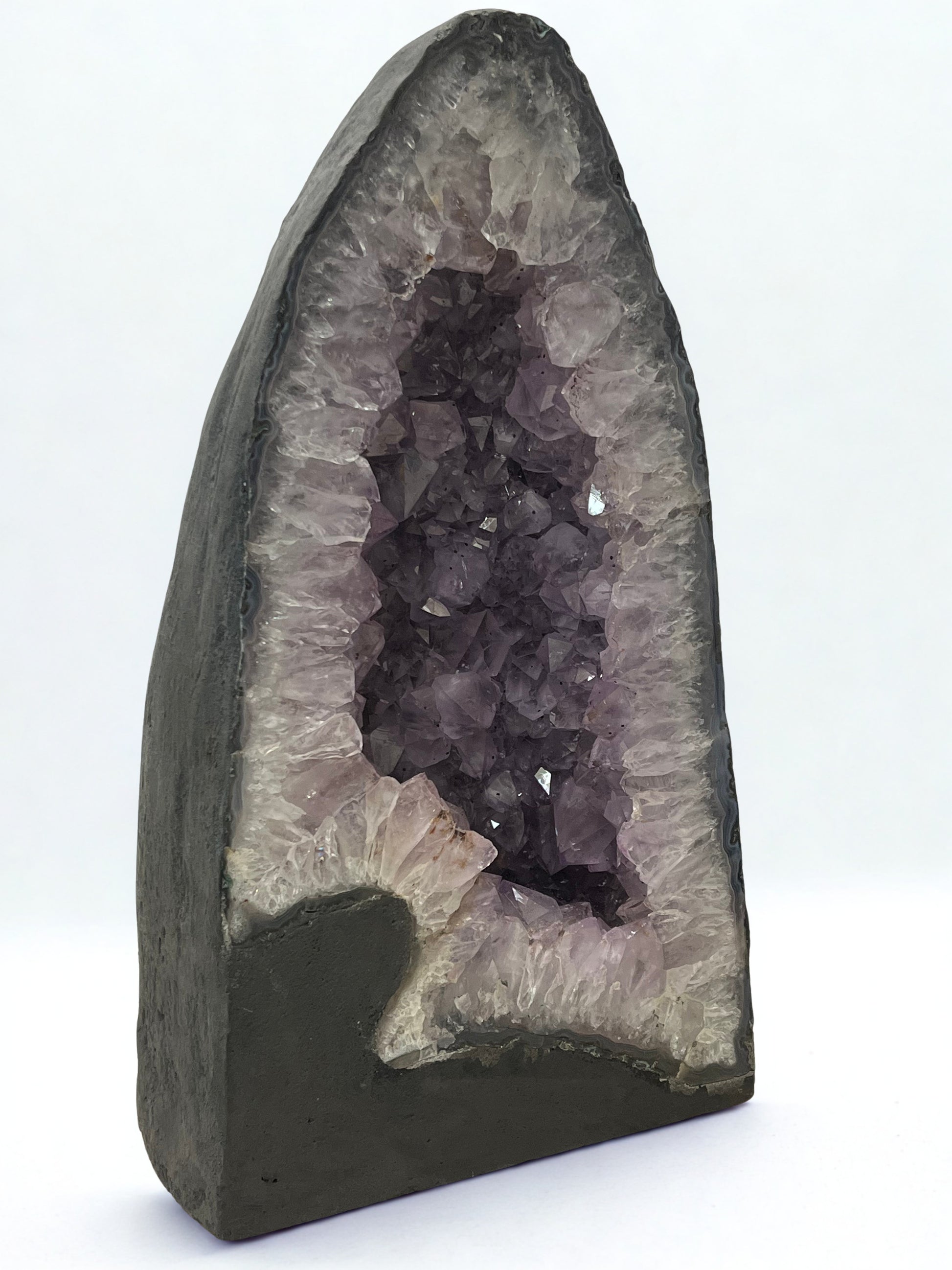 Geode with purple crystals on a white background