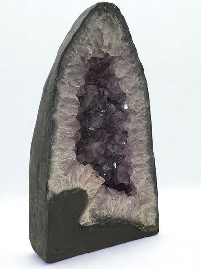 Geode with purple crystals on a white background