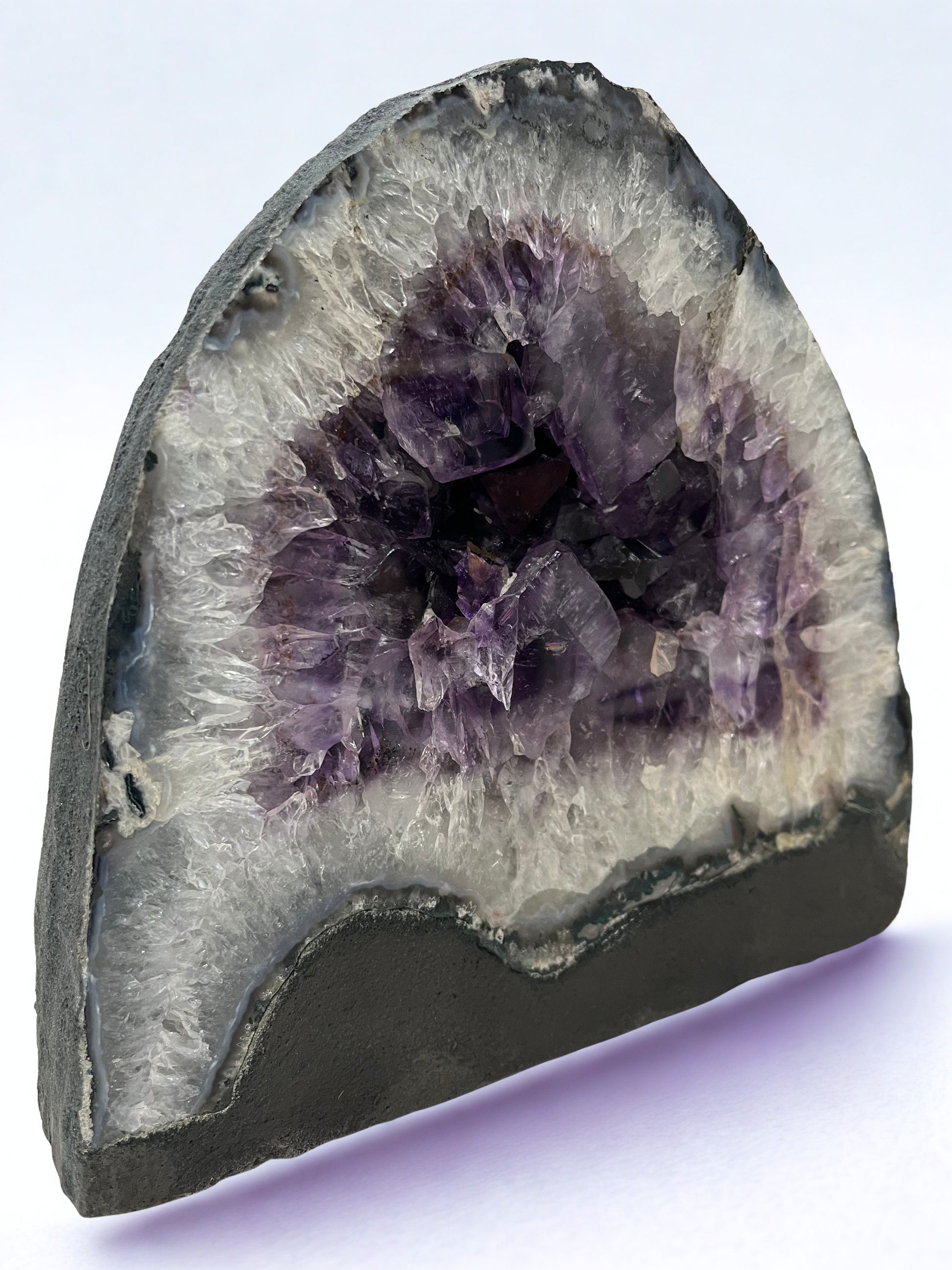 Amethyst geode with a purple interior on a white background